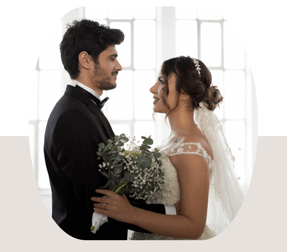 ARTYSIA - Wedding Planner couple gazing at each other with wedding bouquet in a romantic setting
